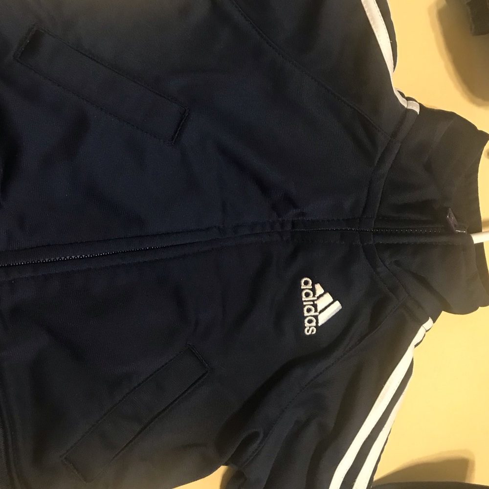 Navy blue and white adidas track suit